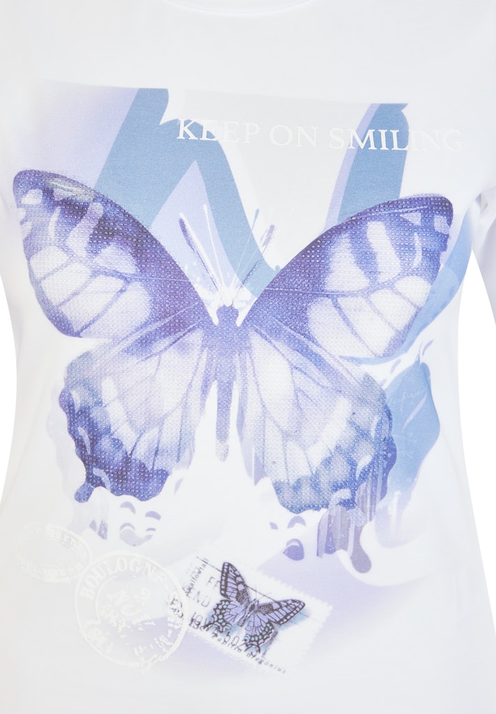 White t-shirt with blue butterfly design 